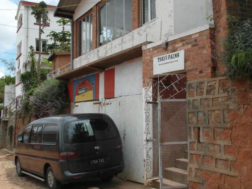 a minivan parked in front of a building at Three Palms Fianar in Fianarantsoa
