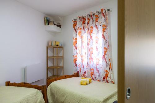 a room with two beds and a curtain at Casa do Forno FR in Mondim de Basto