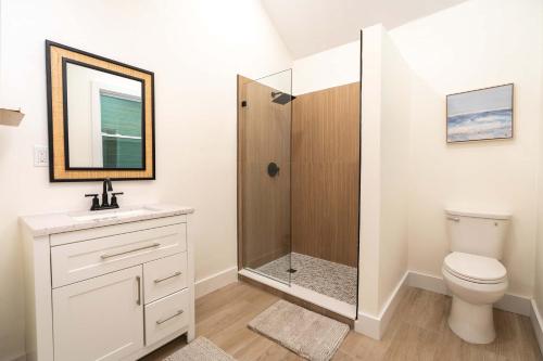 a bathroom with a shower with a toilet and a sink at The Margaret Suite in Key West