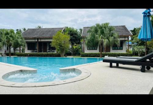 a large swimming pool in front of a house at Navela in Ko Lanta