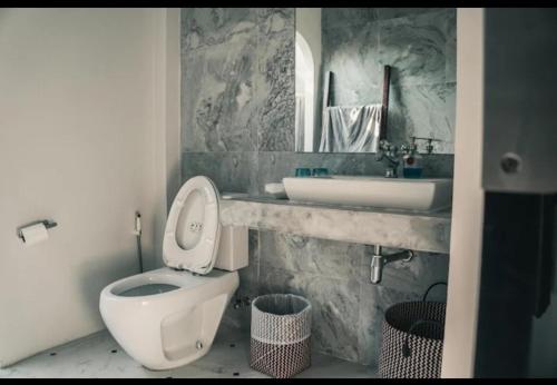 a bathroom with a toilet and a sink at Navela in Ko Lanta