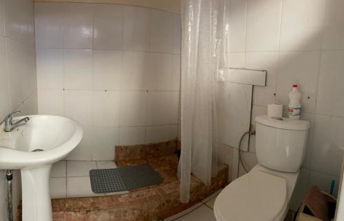 a bathroom with a toilet and a sink at Porto Calheta in Calheta