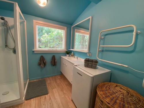 a bathroom with a sink and a mirror at Omarama township location - how good! in Omarama
