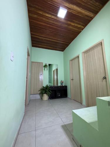an empty room with green walls and wooden ceiling at Aquarium Rooms in Floridablanca