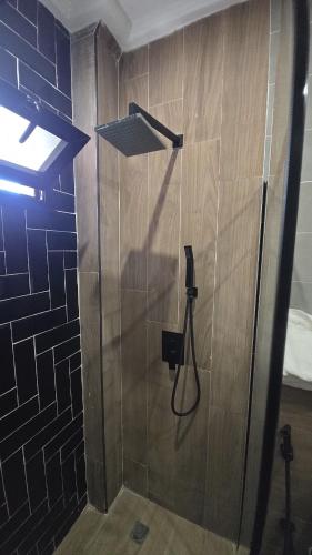 a shower in a bathroom with a glass door at Ouakam Monument de la Renaissance 2 in Dakar