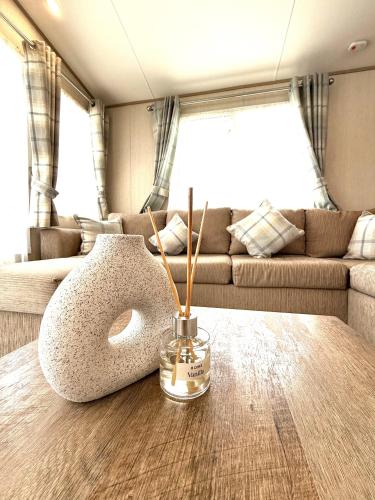 a table in an rv with a vase on it at The Haven in Filey