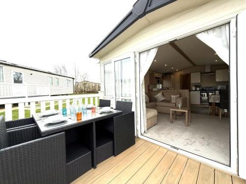 a balcony with a table and a living room at The Haven in Filey