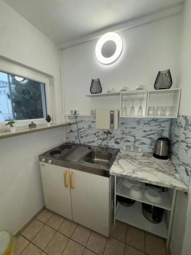 a kitchen with a sink and a counter top at Central CityNest Studio No 8 in Wuppertal