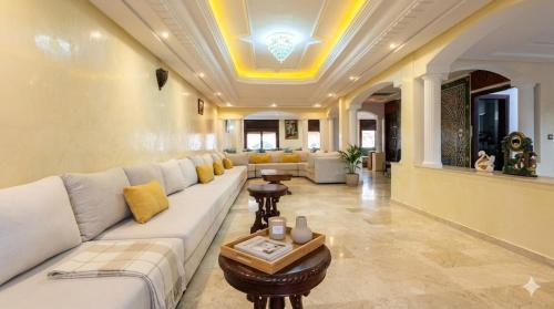 a living room with a white couch and yellow pillows at Palace with Private Pool in Tamaris