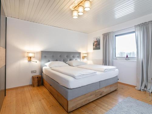 a bedroom with a large bed and a window at Kaiser Chalet Ebbs in Ebbs