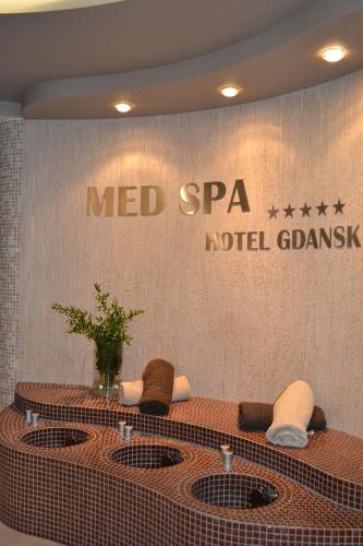 a meeting room with a table and chairs and a sign at Hotel Gdańsk Boutique in Gdańsk