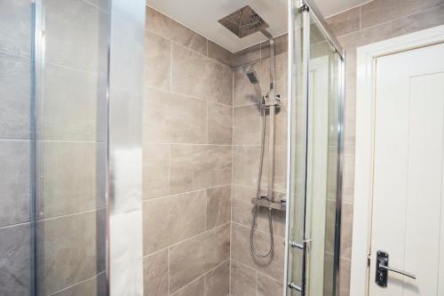 a bathroom with a shower with a glass door at Queensferry Collection - Residence 2 in Derby