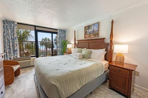 a bedroom with a large bed and a window at Amazing View Ocean Front Studio Nicely Decorated in Myrtle Beach