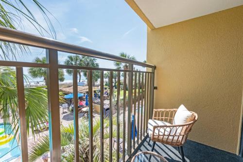 a balcony with a chair and a view of a beach at Amazing View Ocean Front Studio Nicely Decorated in Myrtle Beach