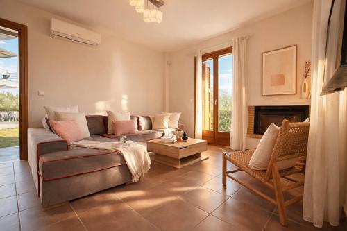 a living room with a couch and a chair at Epidavros View Villas in Ancient Epidauros