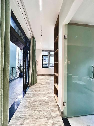 a bathroom with a glass door and a balcony at Win Home Huế in Hue