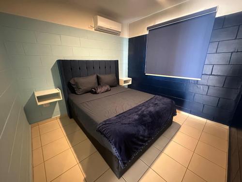 a small bed in a room with a window at Acapulco in Mazatlán