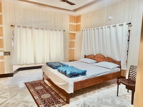 a bedroom with a bed and a window at Lotus palm in Deoghar