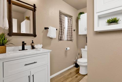 a bathroom with a white sink and a toilet at Shiloh Woods Cabin Walk to Lake & Village Fireplace Cozy Retreat in Big Bear Lake