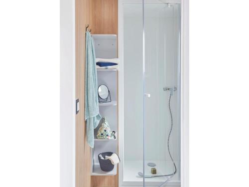 a bathroom with a shower and a glass door at Mobile home Keiheuvel 6p in Balen
