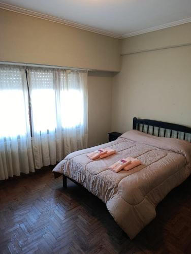 a bedroom with a bed with two towels on it at Sierras & Urbana in Tandil