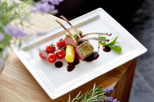 a white plate of food on a table at Hotel Tirol Fiss 4Sterne Superior in Fiss