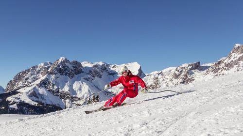 a person is skiing down a snow covered mountain at Landgasthof Reitsamerhof in Werfen