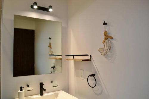 a bathroom with a sink and a mirror at Encanto Department We Bill in Alcocer