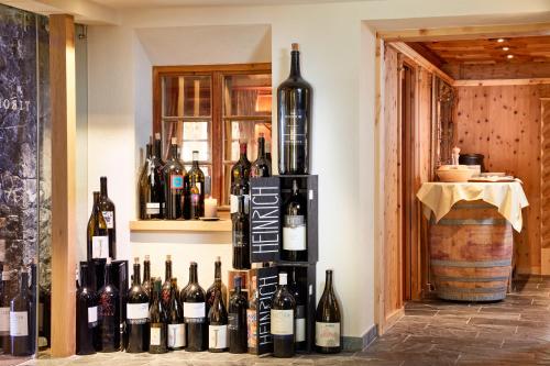 a bunch of bottles of wine sitting on a wall at Hotel Tirol Fiss 4Sterne Superior in Fiss