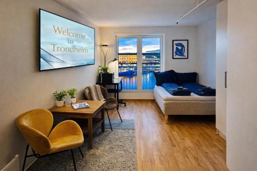 a living room with a couch and a table at Central-Trondheim Riverside Studio-Apartment in Trondheim