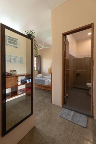 a bathroom with a glass door leading to a bedroom at Yapak Beach Villas in San Isidro