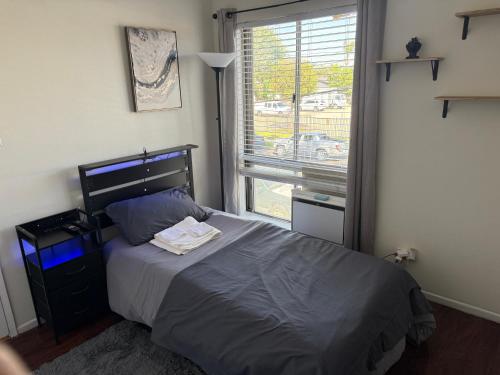 a bedroom with a bed and a large window at Carson in Carson