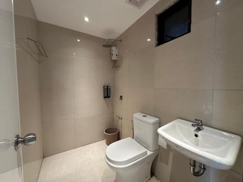 a bathroom with a toilet and a sink at Balay Inato Pension in Puerto Princesa City
