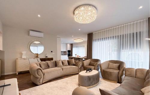 a living room with a couch and chairs and a table at Lovely Apartment In Rovinj in Rovinj