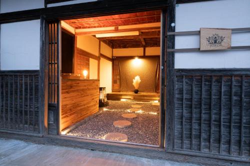 an open door of a building with a courtyard at 古民家宿torch in Fujikawaguchiko