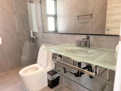 a bathroom with a sink and a toilet at Akara Poolvilla Naithon Beach in Ban Sakhu