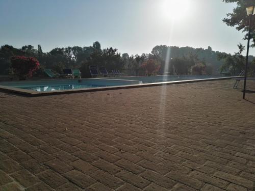 a swimming pool with a fountain in a brick yard at Agriturismo Nestore in Nestore
