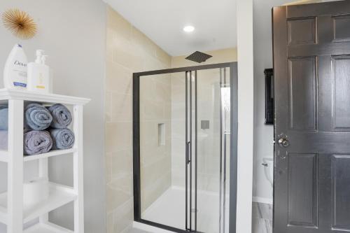 a bathroom with a shower with a glass door at Summit Sanctuary with EV Ready Mountain Views in Poughkeepsie