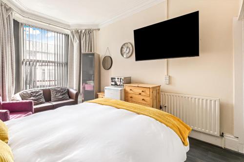 a bedroom with a bed and a flat screen tv at The B & B Blackpool in Blackpool