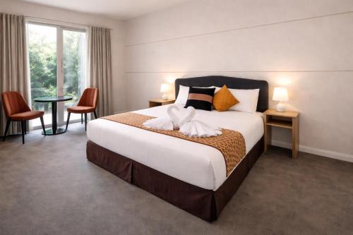 a hotel room with a large bed and a window at De'Vine Escape in Dixons Creek