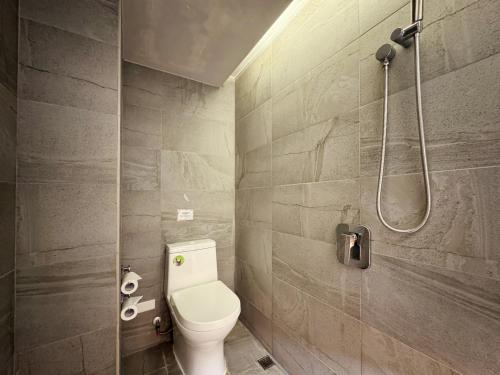 a bathroom with a toilet and a shower at Goodmore Hotel in Taipei
