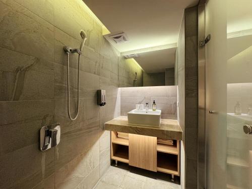 a bathroom with a sink and a shower at Goodmore Hotel in Taipei