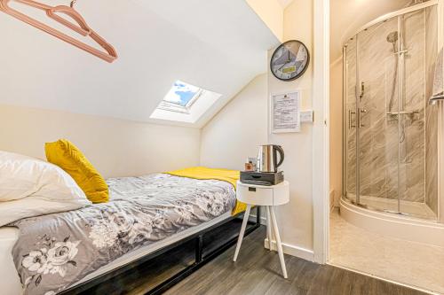 a small bedroom with a bed and a clock on the wall at The B & B Blackpool in Blackpool
