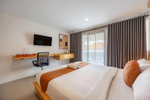 a hotel room with a large bed and a window at Cove Wong Village in Tumbak Bayuh
