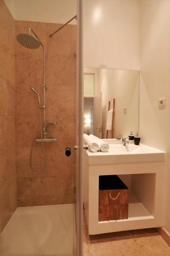 a bathroom with a shower and a sink and a shower at We Love F Tourists in Lisbon