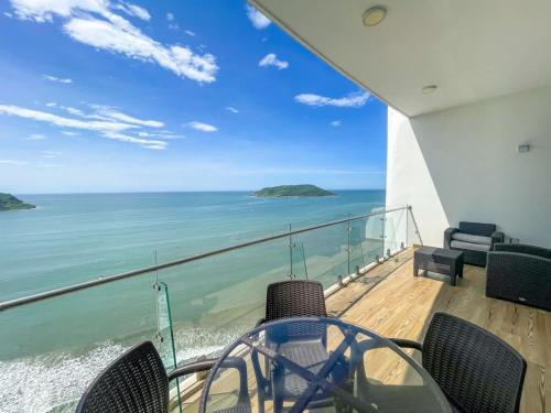 a balcony with chairs and a view of the ocean at Luxe Oceanfront Condo in Golden Zone in Mazatlán