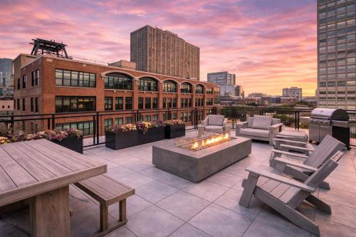 a rooftop patio with a fire pit and a building at Modern 2BR in South Loop Near Soldier Field, Grant Park, Downtown, & Lakefront Trail in Chicago