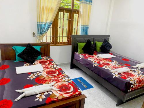 two beds sitting next to each other in a room at Haritha Villa Yala in Kirinda