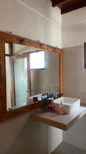 a bathroom with a sink and a mirror at Biru Meno Beach Bungalows in Gili Meno