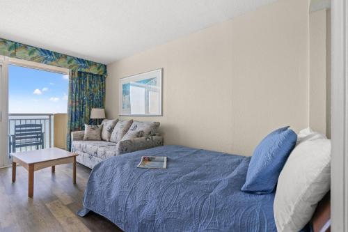 a living room with a bed and a couch at Oceanfront Bay Watch 1BR with Resort Amenities 1707 in Myrtle Beach